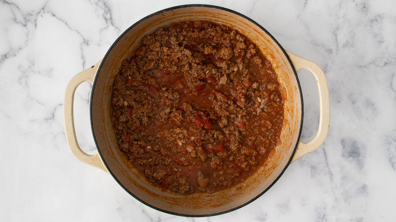 meat and tomatoes in pot