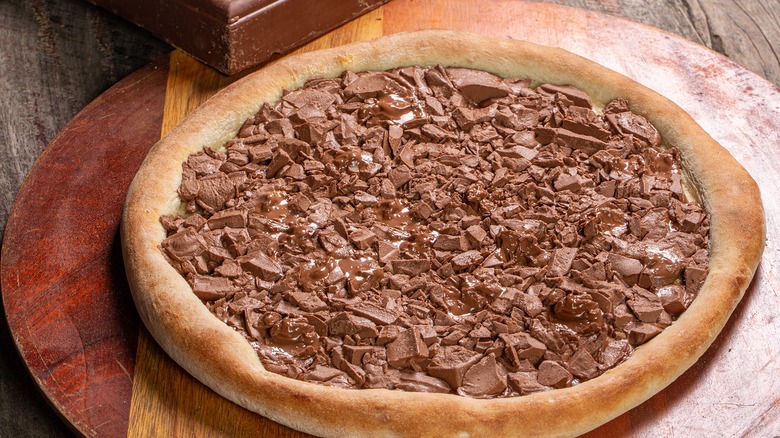 Chocolate pizza on wooden board