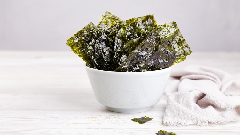 Seaweed snack pieces in a white bowl