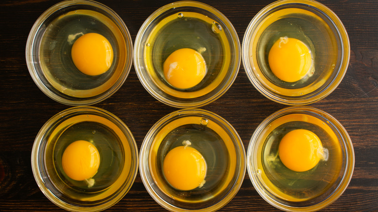 Raw eggs cracked in a jar