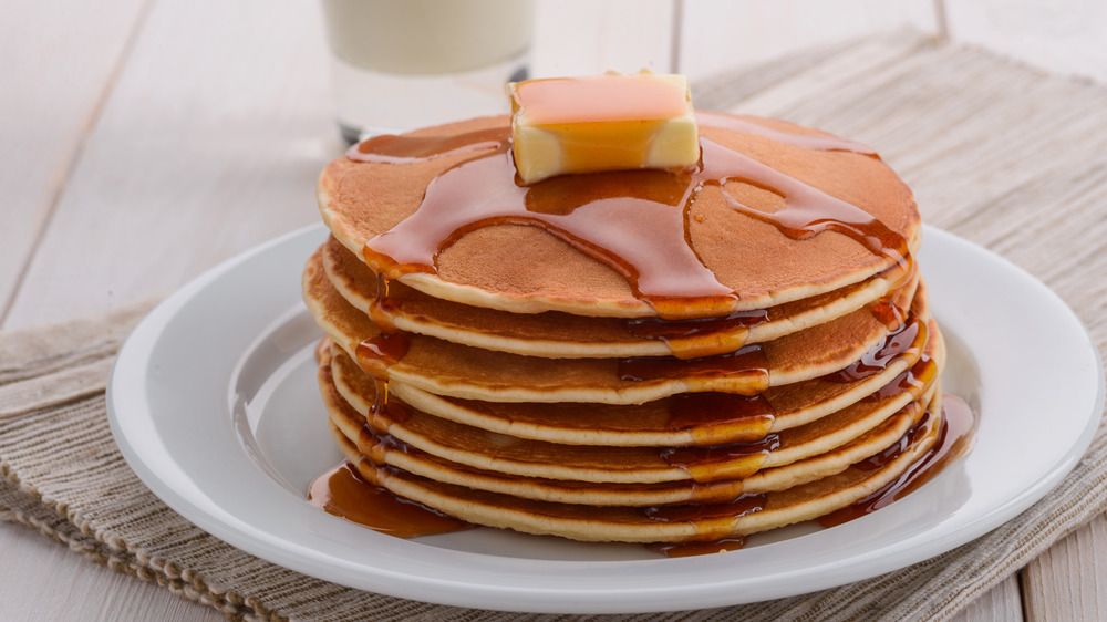 pancake stack topped with syrup and butter