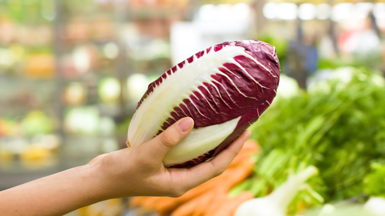 woman hand choosing radicchio at the supermarket 