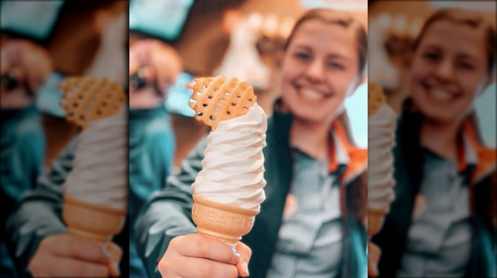 woman holding a Chick-fil-A cone with a fry on top