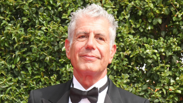 Anthony Bourdain in a tuxedo outside