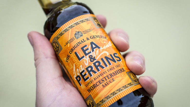 Hand holding bottle of Lea & Perrins Worcestershire sauce