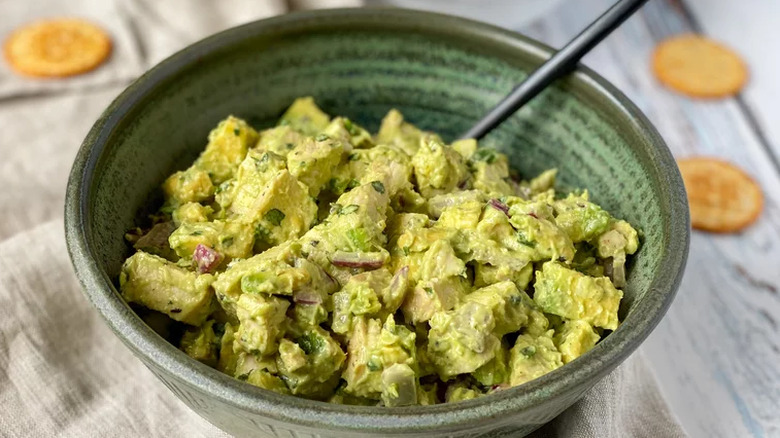 Chicken salad coated in green avocado dressing.