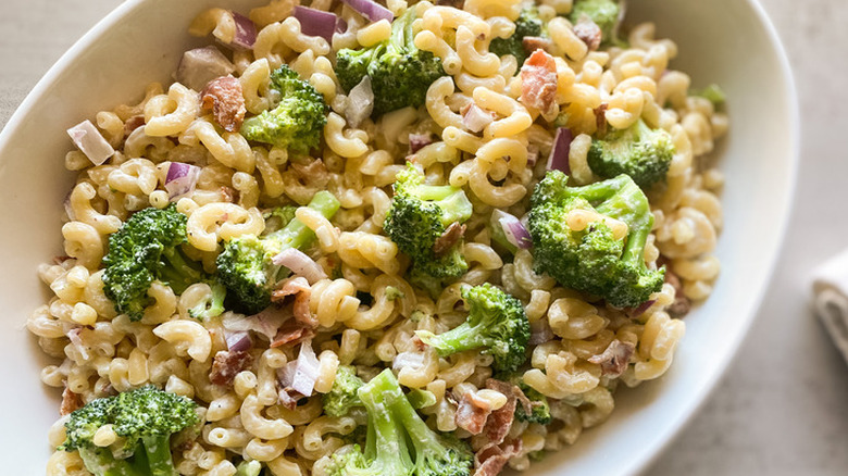 Cooked macaroni with broccoli, onions, and mayonnaise.