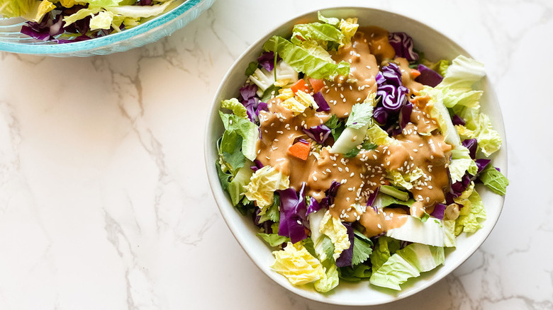 Shredded cabbage with peanut butter sauce and sesame seeds.