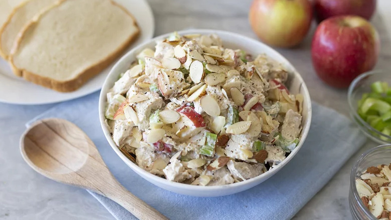 Bowl of mayonnaise-based chicken salad with almonds.