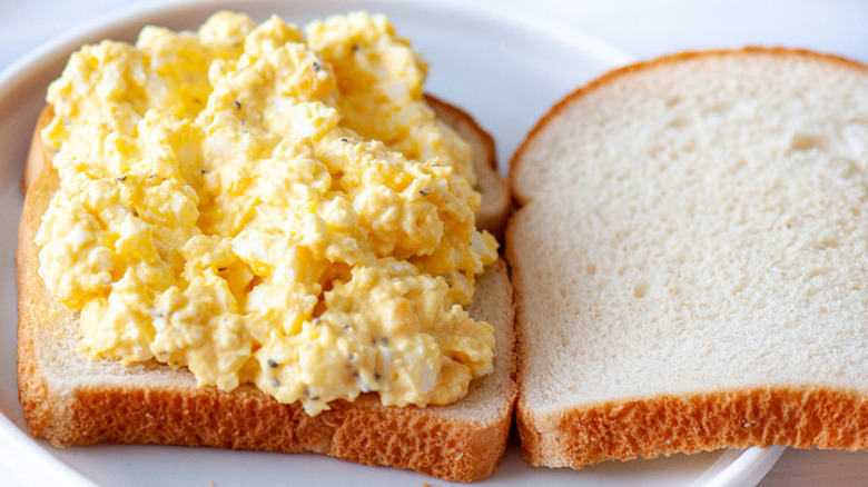 Yellow egg salad on a slice of white bread