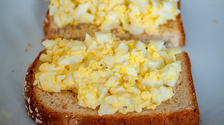 Bread slice with egg salad on top.