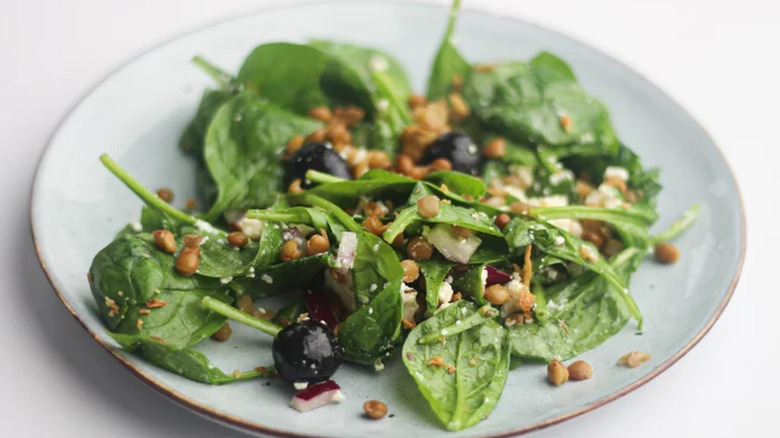 Plate with spinach, lentils, olives, and cheese