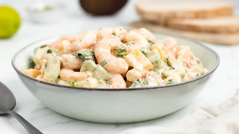 Creamy salad of shrimp and mango in a bowl.