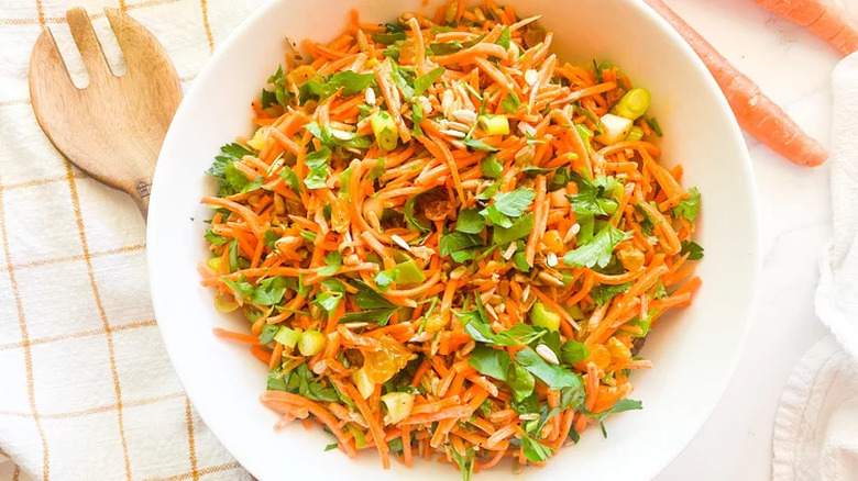 Bowl of shredded carrot salad with parsley
