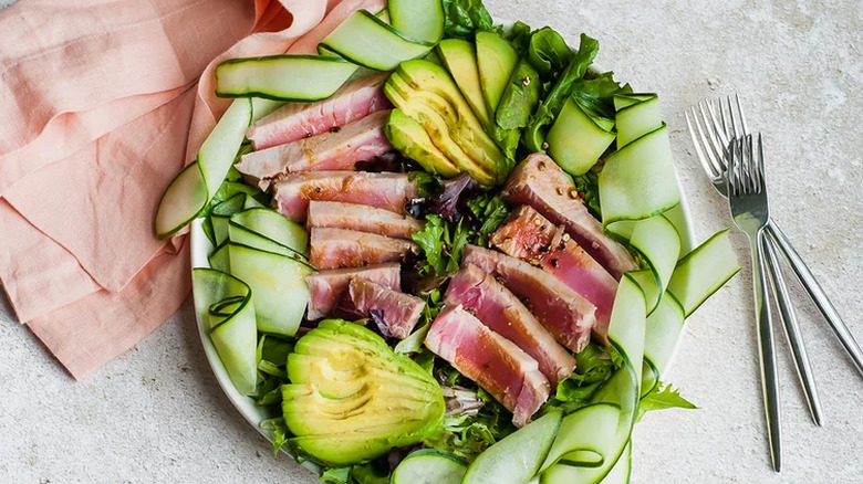 Composed salad of tuna filets, cucumber ribbons, and avocado