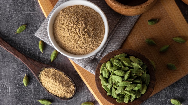 ground cardamom and pods in bowls