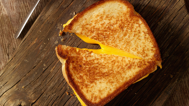 Grilled cheese sandwich on rustic wood table