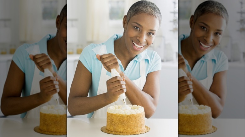 young woman frosting a cake