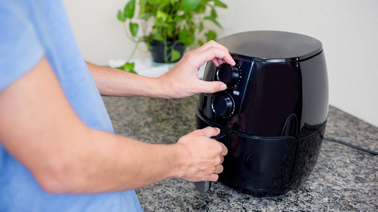 Man using air fryer