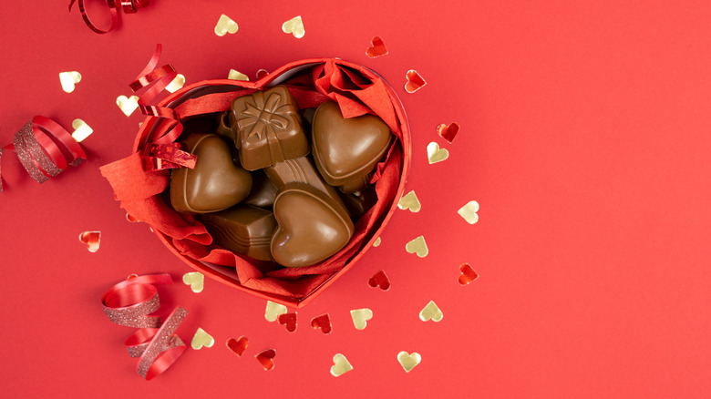 A heart-shaped red box of chocolates