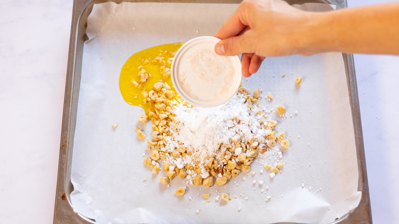 hazelnuts, butter, and icing sugar on lined tray 