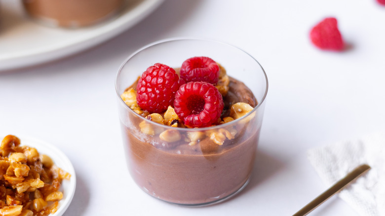 spoon going into chocolate mousse pots