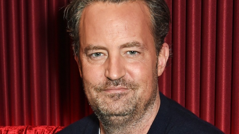 Matthew Perry with red curtain