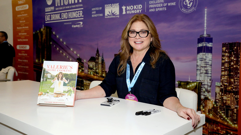 Valerie Bertinelli sitting at table for book signing