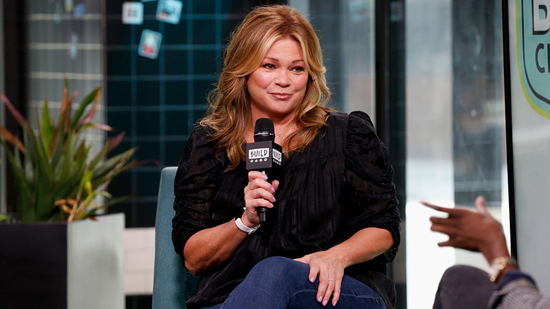 valerie bertinelli giving interview while holding microphone