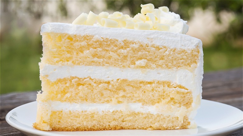 Slice of yellow cake with white buttercream frosting