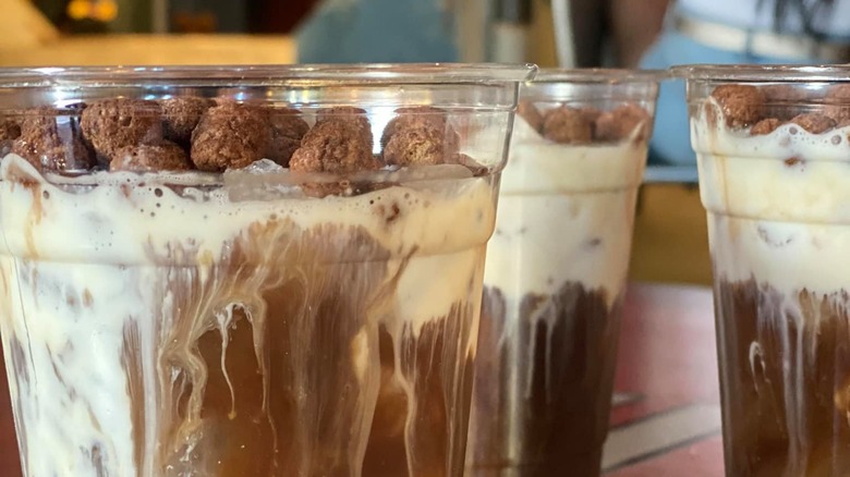 Close up of the top of three cocoa puffs lattes