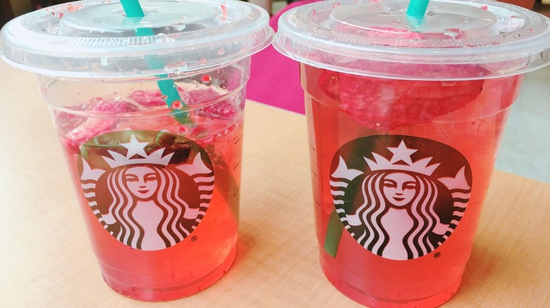 Two pink iced Starbucks drinks