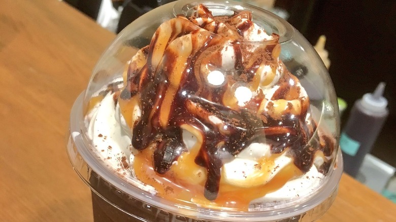 Frappuccino topped with cream, mocha and caramel sauce