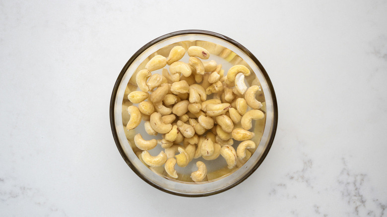 cashews soaking in bowl of water