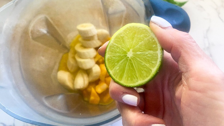 blender with ingredients and lime
