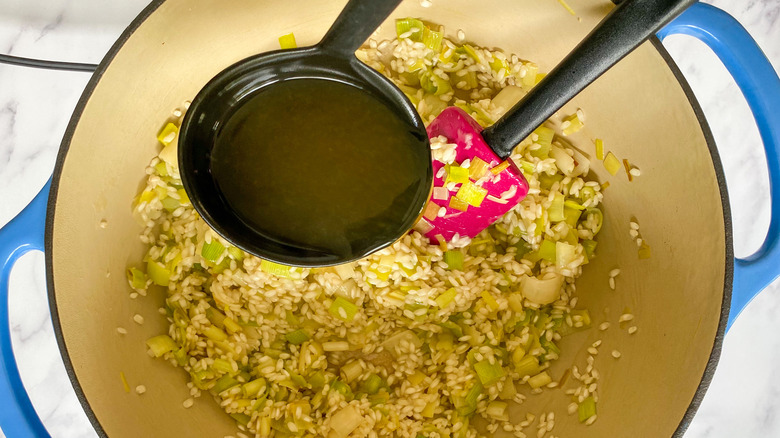 ladle pouring broth into pot