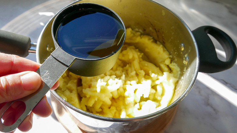 pouring oil into mashed potatoes