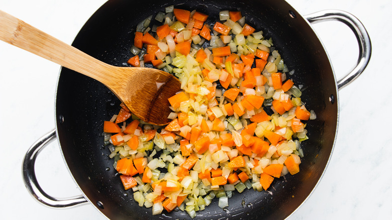 Onion and carrot cooking in pot