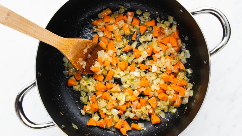 Onion and carrot cooking in pot