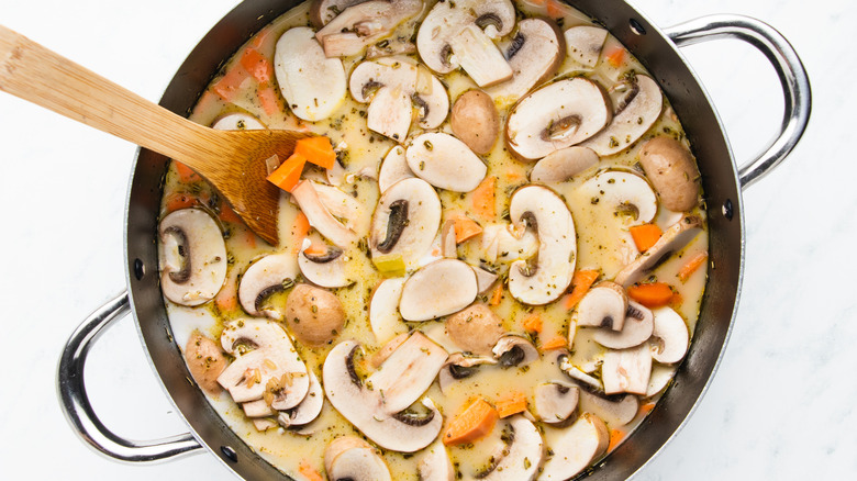 Mushroom and sweet potato soup in pot