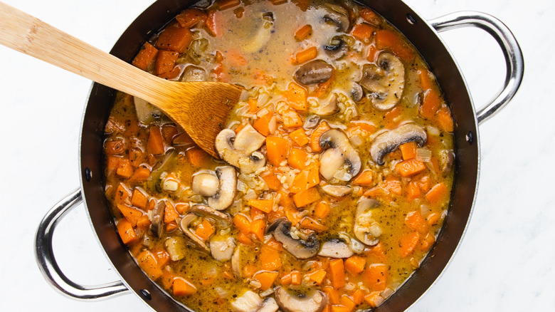 Mushroom and sweet potato soup in pot