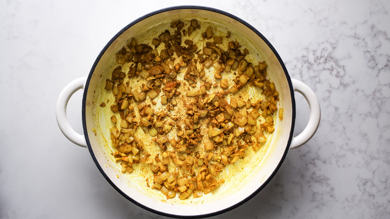 spices and aromatics in Dutch oven