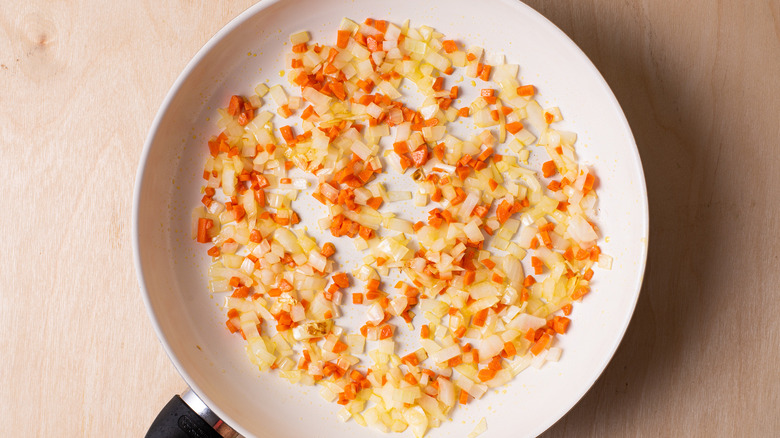 Sauteed carrots and onions in a skillet
