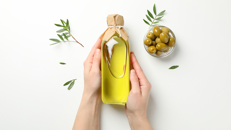 Bottle of olive oil on white background