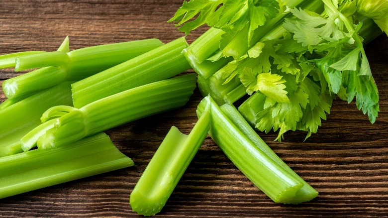 pile of celery stalks on wood board