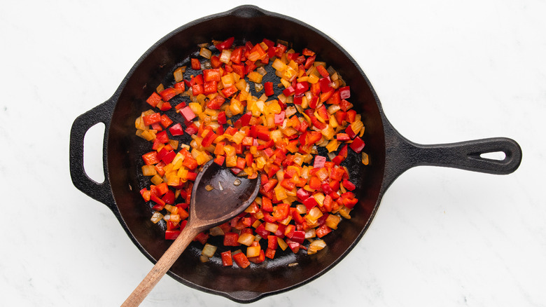 Diced pepper and onion in cast iron skillet