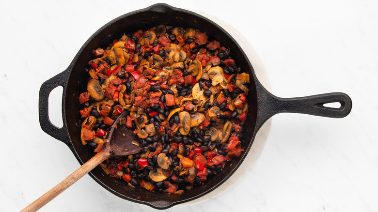 Black beans and vegetables in cast iron skillet