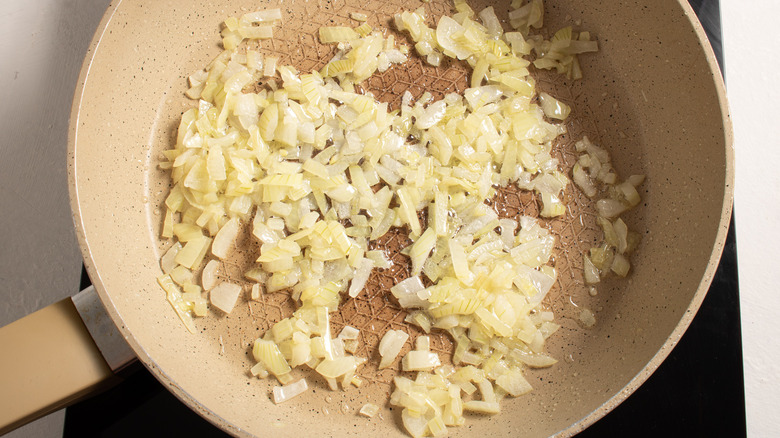 diced onions sauteing in pan