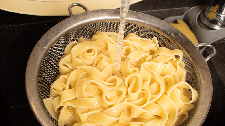 rinsing pasta in colander
