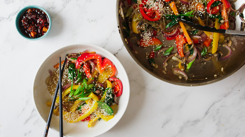 pan and bowl of noodles 